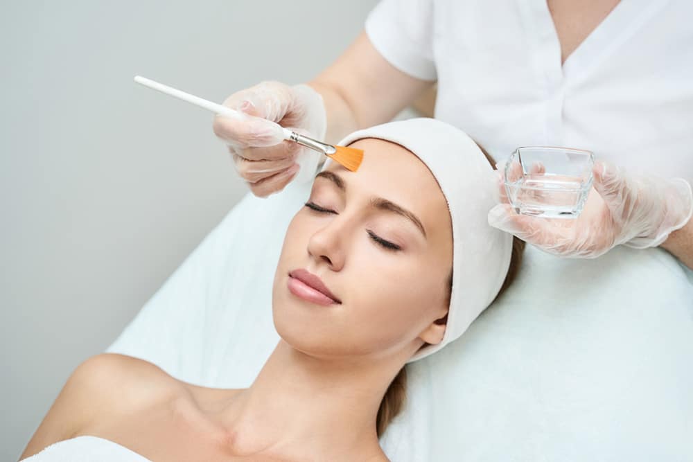 Mature woman applying cream after Pasadena anti-aging treatments at Dynasty Dermatology Pasadena, CA