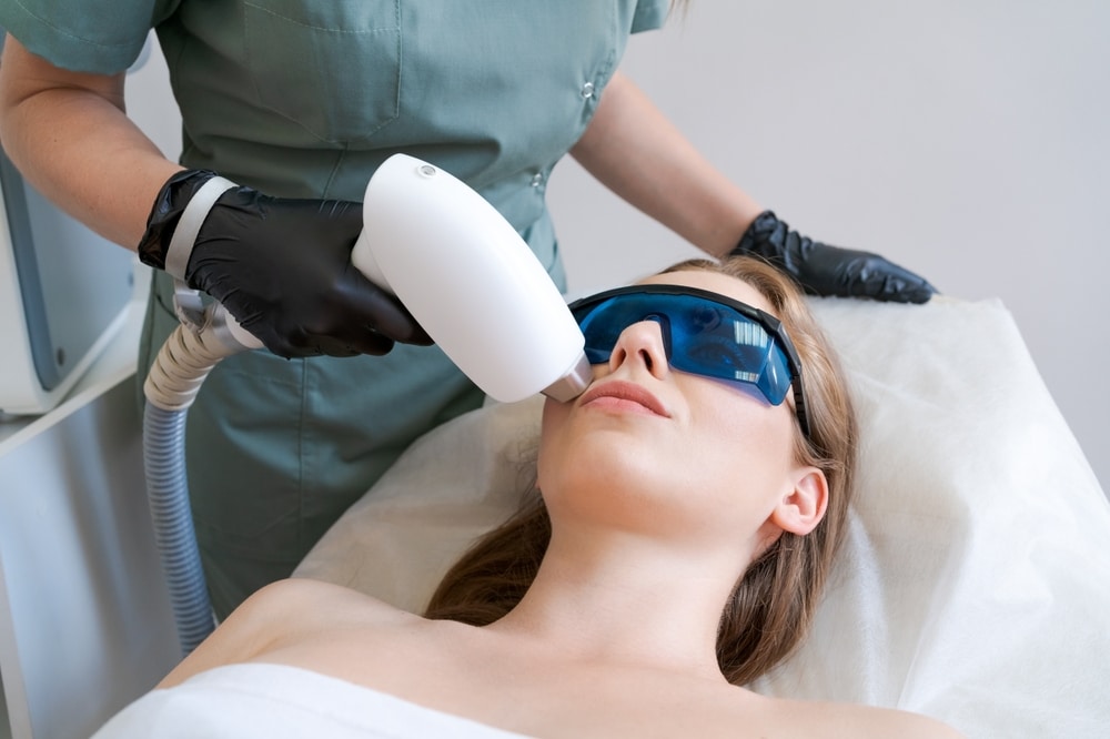 Dermatologist performing a facial with laser